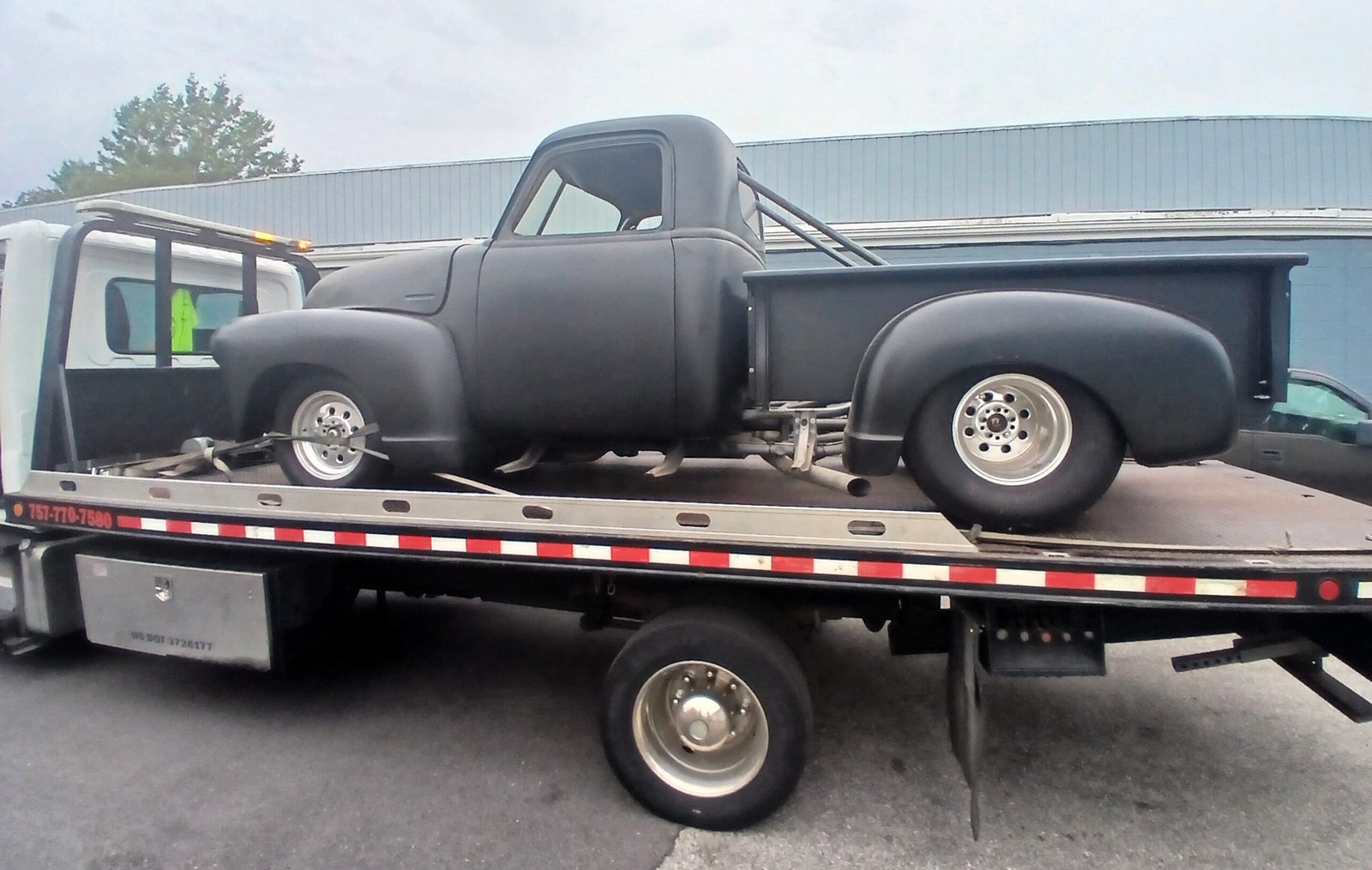 Spartan Towing loading a low-clearance specialty vehicle